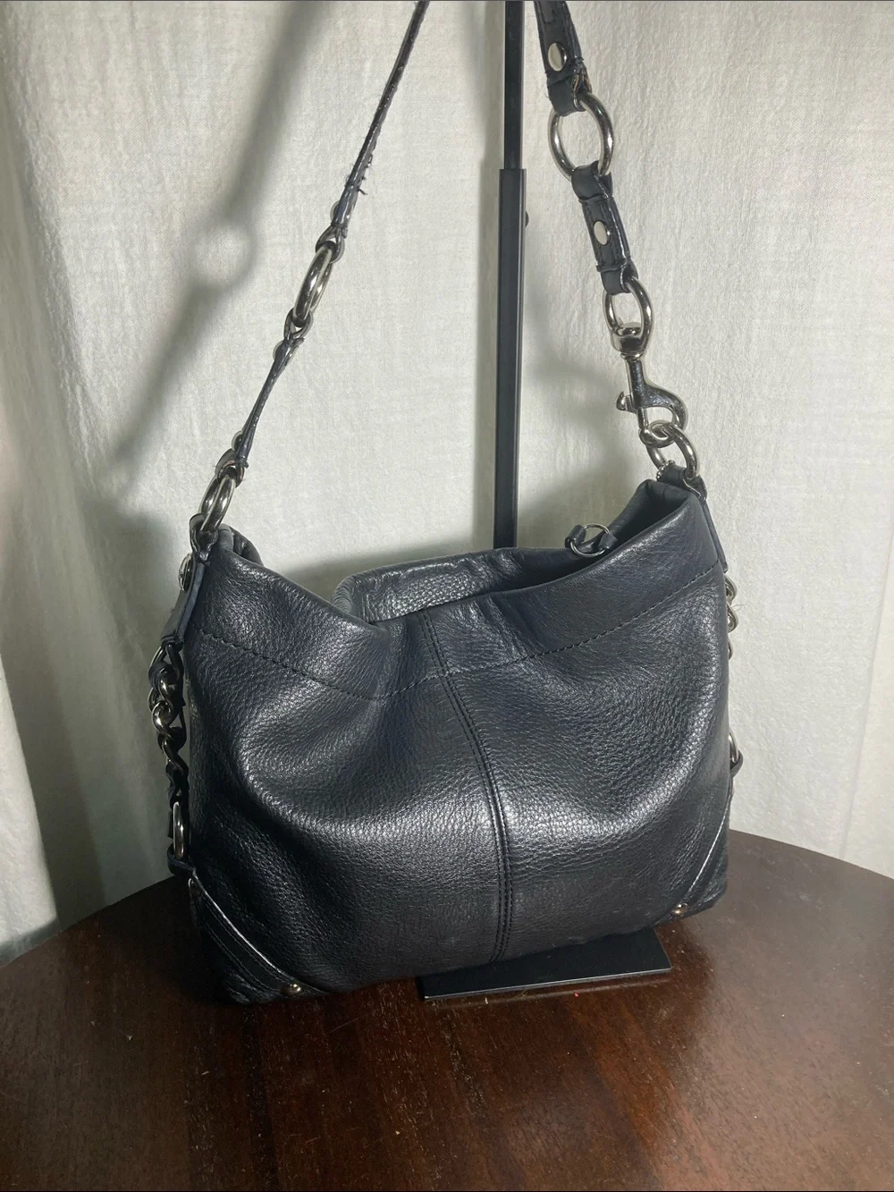 Coach black pebbled leather Carly hobo shoulder bag with silver hardware.